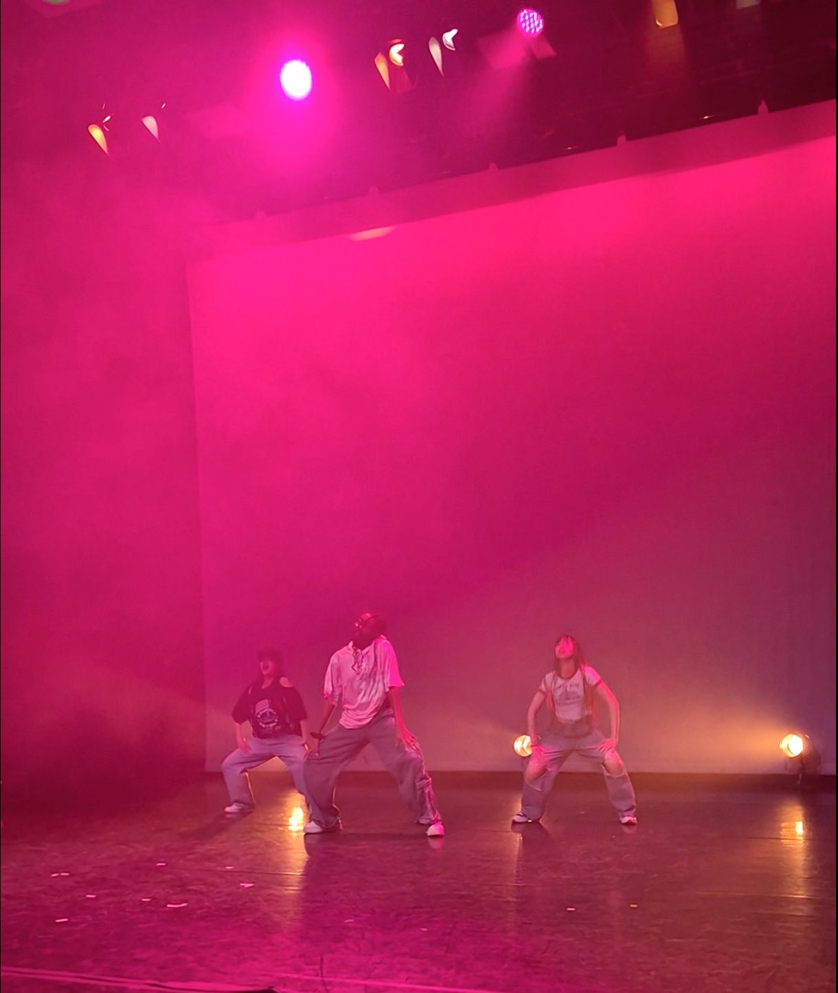 Students at Pendleton's Got Talent dancing on a stage that is lit purple